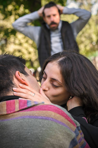 istock Adultery and infidelity. Girlfriend cheating his jealous boyfriend. 1348661752