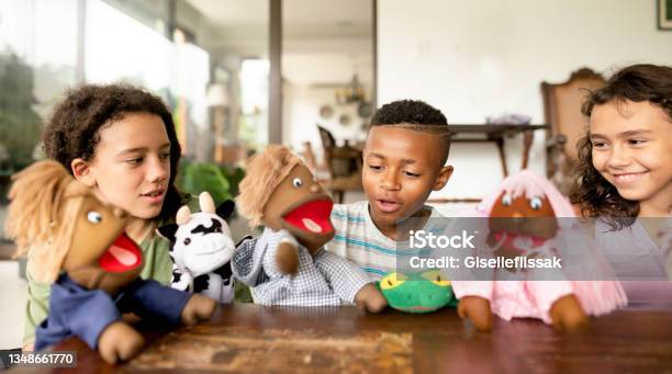Smiling Children Putting On A Play Together With Hand Puppets Stock Photo - Download Image Now