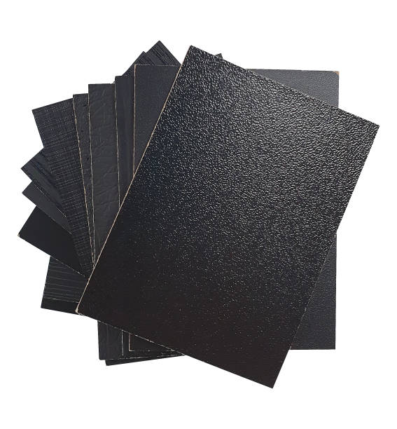 top view stacked of melamine samples in various surface contains wooden, fabric, stone, leather, pearl, matt surface textures in black color, isolated on white background with clipping path.