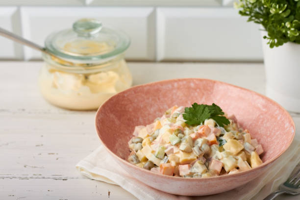 istock traditional russian salad (olivier) white background 1348669396