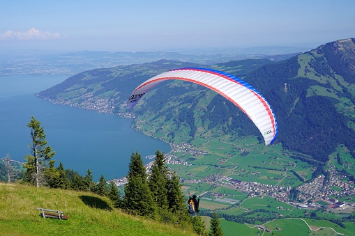 Rigi Kulm, Switzerland 08 14 2021 Paraglide flight above lake Zug and surrounding area in Rigi region, central Switzerland.