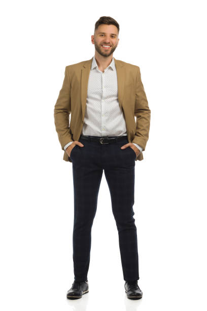istock Relaxed elegant man in beige jacket is standing with hands in pockets. Front view. Full length isolated. 1348671476
