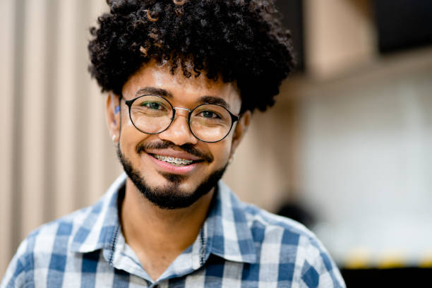 istock Young businessman smiling while standing in a modern office 1348671636