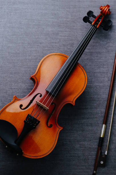 istock A violin on a grey textile surface. It's in a perfect condition. 1348671642