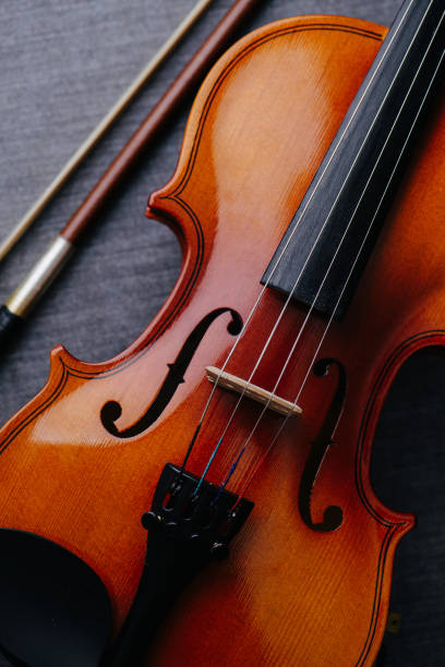 istock Close up image of a new violin on a grey textile surface 1348671650