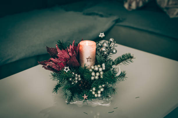 burning candle on decorated christmas table