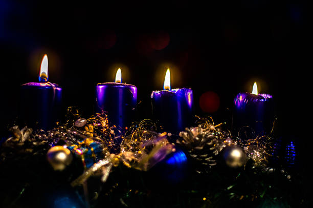 four mettalic blue burning candles on advent wreath, dramatic and contract, christmas concept stock photo