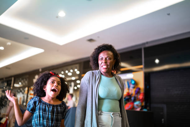 istock Mother and daughter walking and talking at the mall 1348674316