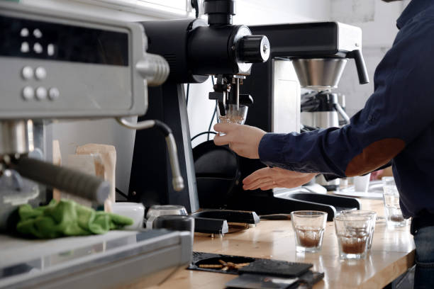 istock Grinding fresh coffee into glass cups for cupping 1348675736