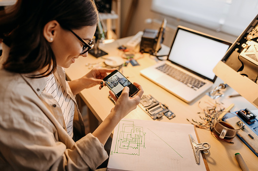 Female engineer photographs a sketch she drew over the phone