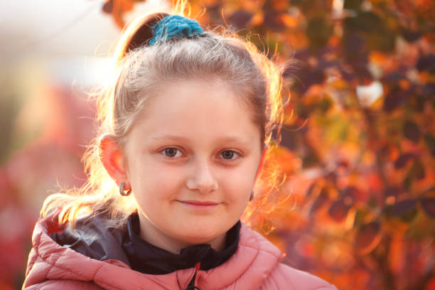 Portrait of young blonde girl in the autumn