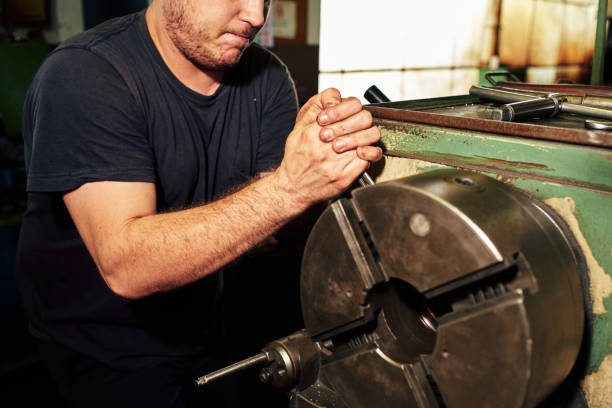 istock Professional machinist : man operating lathe grinding machine 1348684802