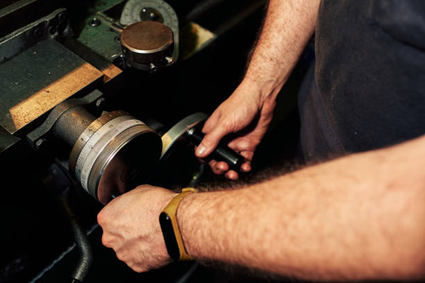 istock Professional machinist : man operating lathe grinding machine 1348685355