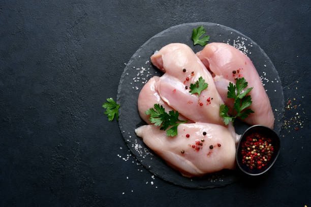 istock Raw organic chicken breasts with ingredients for making 1348692578