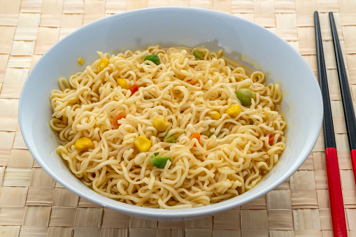 Curried noodles with peas, sweetcorn and carrots.