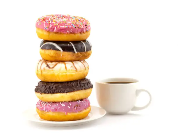 Photo of Sweet colorful donuts and coffee cup. Concept background of world problem of obesity and unhealthy nutrition