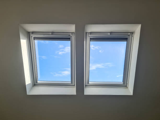 Skylights in loft conversion showing blue sky with a few small clouds Skylights in loft conversion showing blue sky with a few small clouds skylight stock pictures, royalty-free photos & images