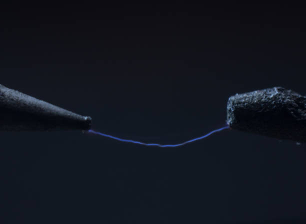 istock Electric cable close-up with glowing electricity lightning. Macro shot 1348709135