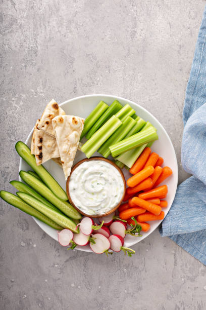 istock Large snack board with tzatziki dip or sauce and fresh vegetables 1348716560