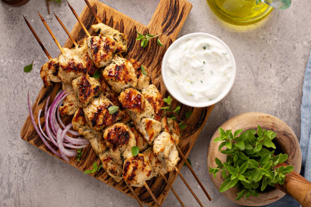 Greek chicken souvlaki with tzatziki Greek chicken souvlaki with tzatziki sauce and fresh vegetables, grilled kebabs chicken skewer stock pictures, royalty-free photos & images
