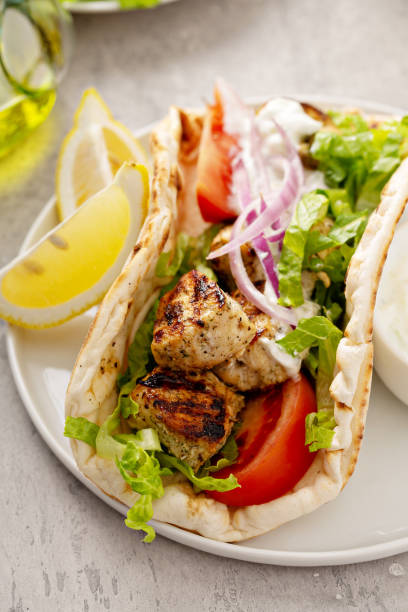 istock Chicken souvlaki with fresh vegetables on a flatbread 1348716584