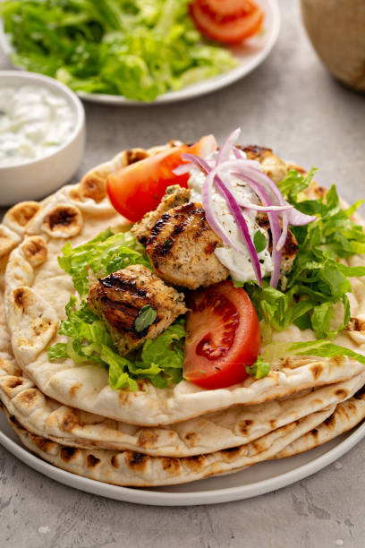 istock Chicken souvlaki with fresh vegetables on a flatbread 1348716587