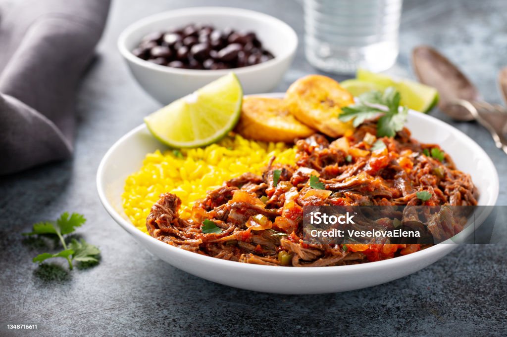 Ropa vieja, flank steak dish with rice Ropa vieja, traditional flank steak dish with rice, cuban beans and plantains Ropa Vieja Stock Photo