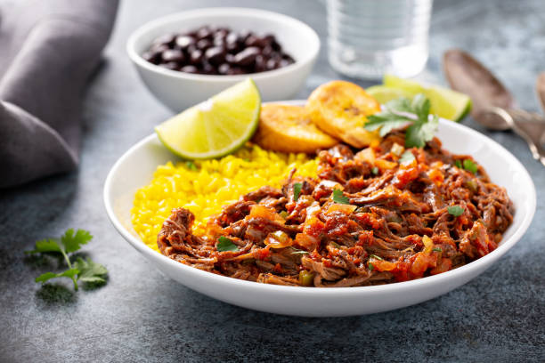 Ropa vieja, flank steak dish with rice Ropa vieja, traditional flank steak dish with rice, cuban beans and plantains west indies stock pictures, royalty-free photos & images