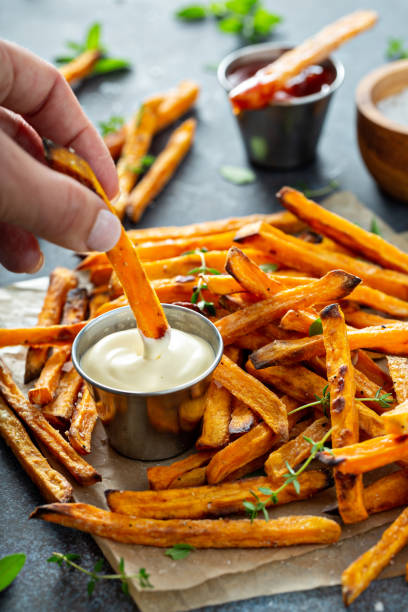 Sweet potato fries with sauces Sweet potato fries with mayo and ketchup, homemade roasted in the oven sweet potato french fries stock pictures, royalty-free photos & images