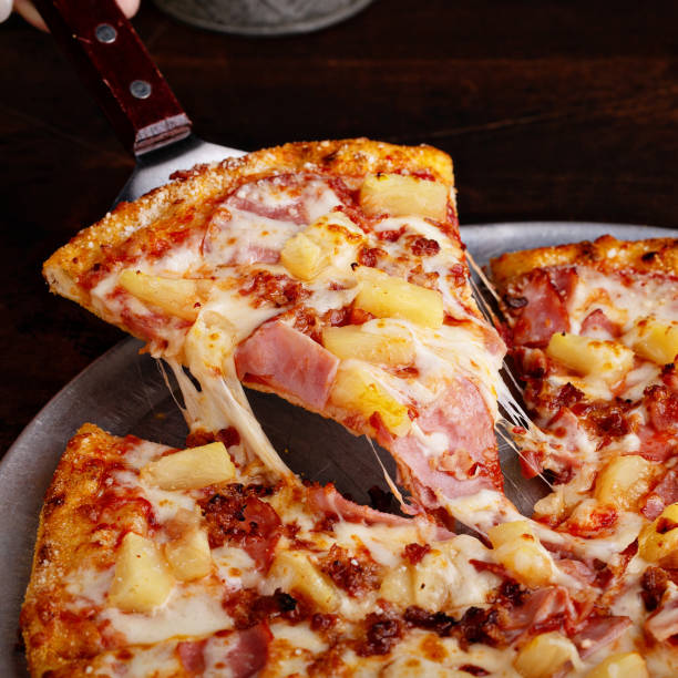 istock Hawaiian pizza with ham and pineapple 1348719510