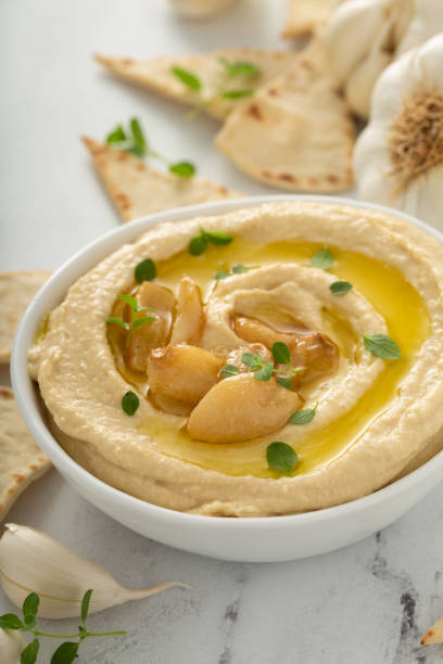 istock Roasted garlic hummus topped with olive oil 1348719546