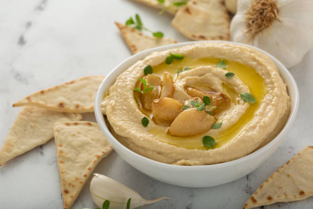 istock Roasted garlic hummus topped with olive oil 1348719608