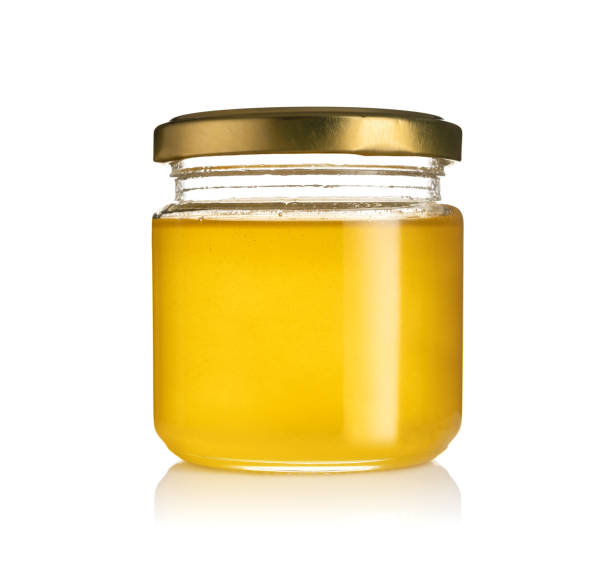 istock honey in a jar isolated on white background 1348730941