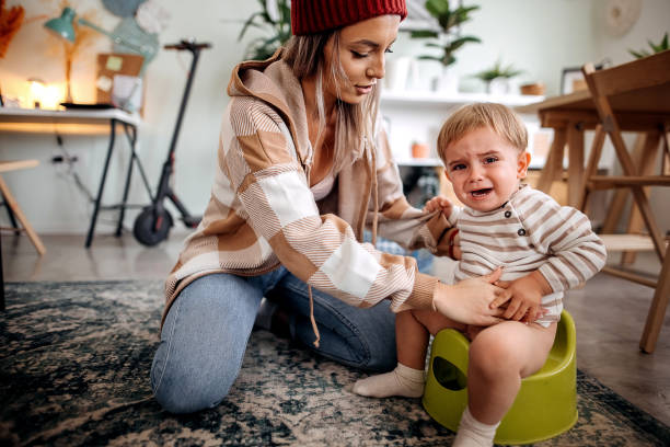 Mother Training Her Son to Use Potty s stock photo