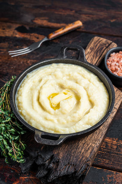 istock Mashed potatoes in a pan on wooden rustic table. Wooden background. Top view 1348756210
