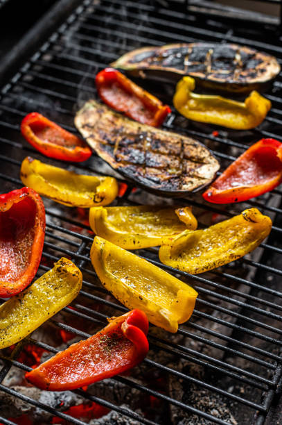 istock Grilled vegetables on barbecue, outdoor BBQ grill with fire. Top view 1348756246