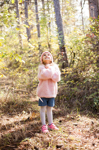 little girl walking in the forest