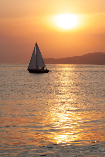 istock Sailboat sailing in a beautiful summer sea during sunset 1348759355