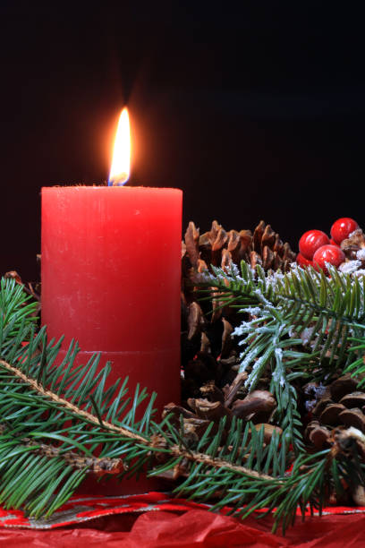 istock Christmas scene with fir branches, pine cones and a candle 1348761216