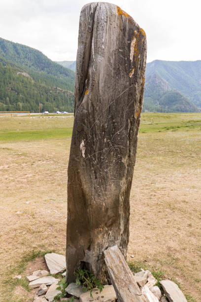istock Ancient stone with primitive drawings on it and damage by modern vandals scratching surface of cultural heritage objects 1348764005