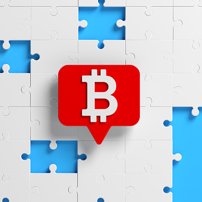 White-colored Bitcoin symbol red-colored speech bubble and white-colored jigsaw puzzle pieces. On blue-colored background. Square composition with copy space. Isolated with clipping path.