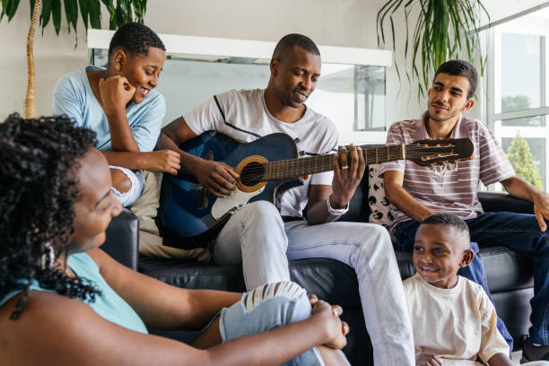 istock Family having fun with guitar at home 1348764907