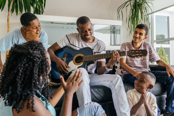 istock Family having fun with guitar at home 1348764917
