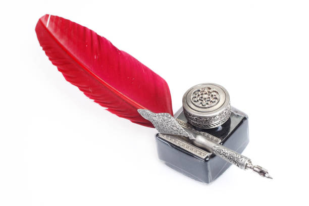 istock Old red fountain pen with inkwell on white background 1348765667