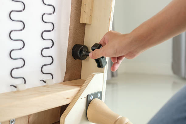 istock Man assembling sofa furniture at home 1348768245