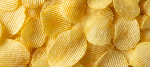 istock crispy golden potato chips snack texture background 1348768264