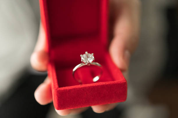 istock hands holding diamond ring in jewelry box 1348768278