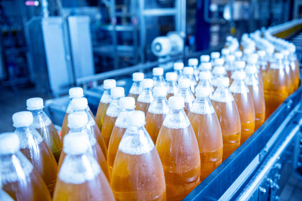 istock Conveyor belt with bottles for juice or water at a modern beverage plant 1348771463