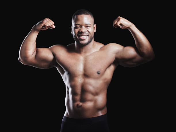istock Studio portrait of a fit young man posing against a black background 1348772390