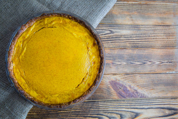 istock Pumpkin pie on rustic wooden table, top view. Space for text, copy space. 1348777935